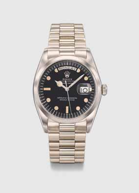 ROLEX A very fine and exceptionally rare 18k white gold automatic wristwatch with sweep centre seconds, day, date, special order luminous black dial, special order sport hands, special order bezel,