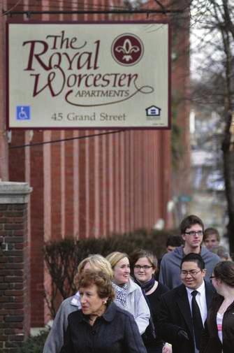 Students, teachers and tour guides walk along Grand Street in Worcester, past the former Royal Worcester Corset Company factory, which is now apartments.