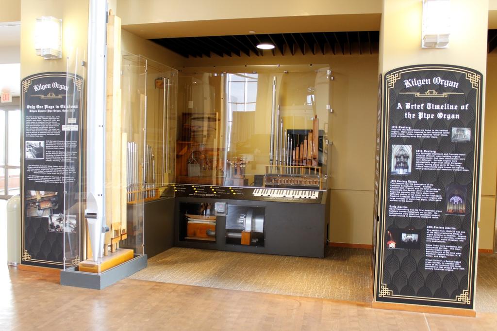 There is a display near the front doors, where I can see pipes and wooden parts of a theatre organ.