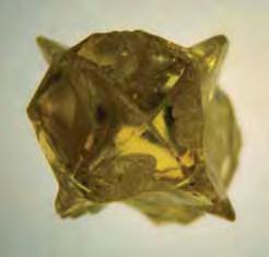 11 ct natural cuboid diamond shows wavy, undulating growth surfaces. (C) This 2.