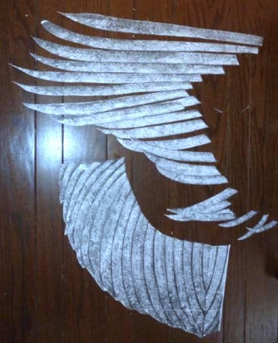 For example, individual feathers (below at top), corresponding to the top-left most section, will be applied to nylon net, and the uncut feathers, once cut out, will be applied to a different piece