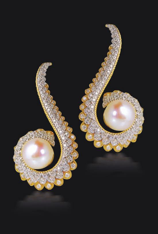 the motif in the form of a pair of earrings accented with diamonds in pave setting with different layers of round