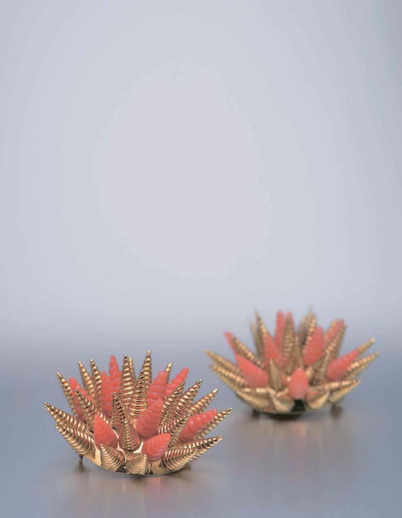 Tiffany & Co. This pair of brooch is designed by Tiffany. Coral and 18K gold has been meticulously carved into the shape of spikes on sea urchins.