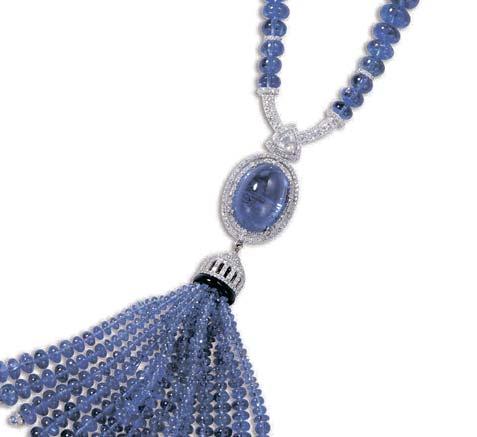 08 carats, within a two-row diamond surround, suspending a diamond and onyx cap and tanzanite bead tassel, to a