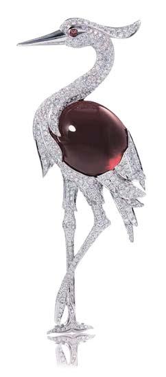 2642 2641 2641 A RUBELITTE AND DIAMOND CRANE BROOCH 103.20 carats, extending diamond wing and legs, enhanced by a cabochon ruby eye, mounted in 18K white gold, 12.