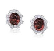 2507 A PAIR OF BURMESE RED SPINEL AND DIAMOND EARRINGS Each set to the center with an oval-shaped red spinel, weighing altogether approximately 8.