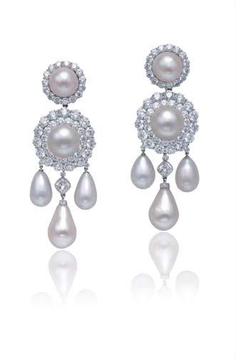2586 2586 A PAIR OF NATURAL PEARL AND DIAMOND EAR PENDANTS within a two rows brilliant-cut diamond surround, suspending three white natural pearl drops, spaced by a cushion cut diamond, to the