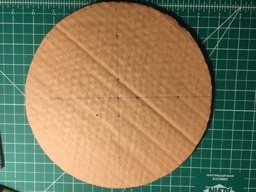 Make a mark in the center of each of piece of cardboard on one side and two marks