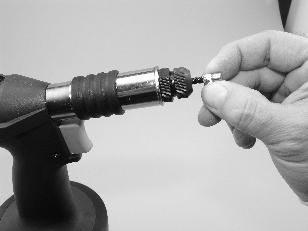 The pressure can be adjusted by the screw set at the bottom of the tool (Fig. ). The tool is provided with a fully automatic air motor for screwing nuts/bolts on and off.