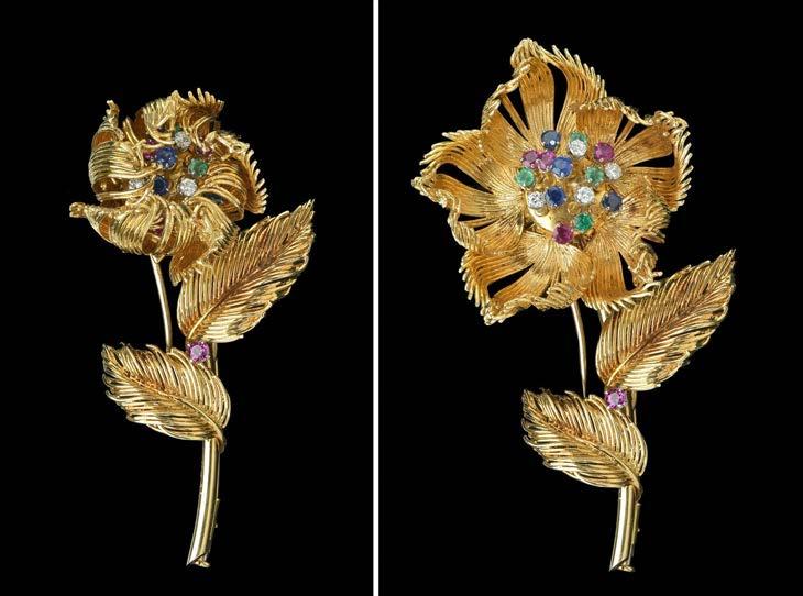 96 A DIAMOND AND GEM SET OPEN AND SHUT FLOWER BROOCH BY CARTIER, CIRCA 1965, the flowerhead with articulated petals opening to reveal tremored stamen claw set with diamonds, emeralds, sapphires and