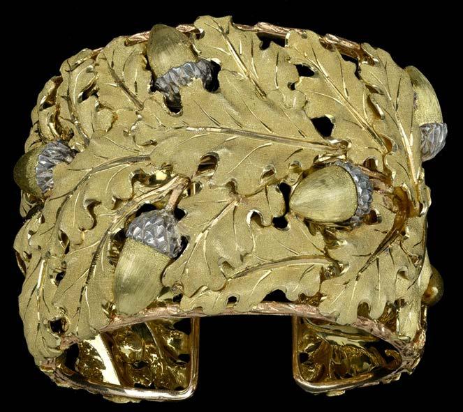 105 A CUFF BRACELET, BY BUCCELLATI, circa 1960s, the 18ct two colour gold hinged bangle designed in the form of overlapping realistically modelled oak leaves and acorns, the cups in textured silver,