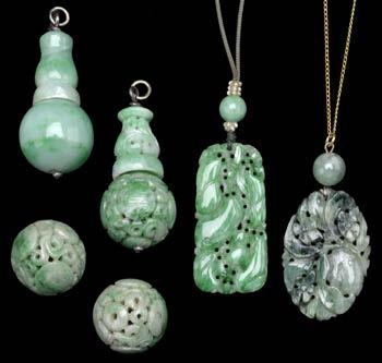 260-360 169 A COLLECTION OF JADE PENDANTS AND BEADS, comprising a rectangular carved jade panel pendant, depicting six gourds and a bird, with jade bead surmount and seed pearl highlights, on silk