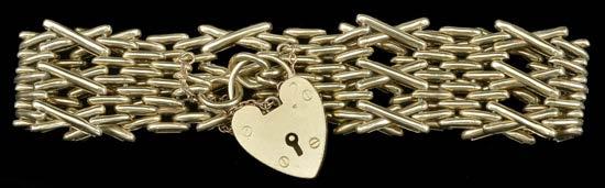 197 A 9CT GOLD GATE-LINK BRACELET, with fancy X-link details, hallmarked for 9ct gold, date letter indistinct, to later 9ct gold heart-shaped padlock clasp, hallmarked for Birmingham, 1963, bracelet
