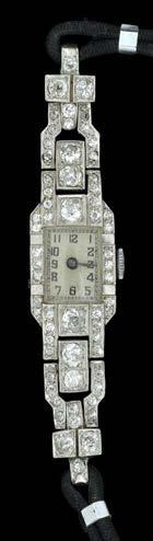 Watches 6 A DIAMOND COCKTAIL WATCH, the tonneau-shaped dial with black Arabic numerals, blued steel hands, within diamond set bezel of brilliant and old-cut diamonds, with pairs of square-cut diamond