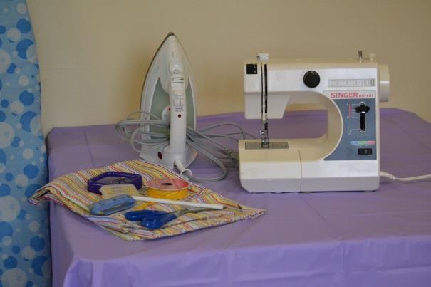 pillowcase, ribbon, sewing machine, thread, a pencil, scissors,