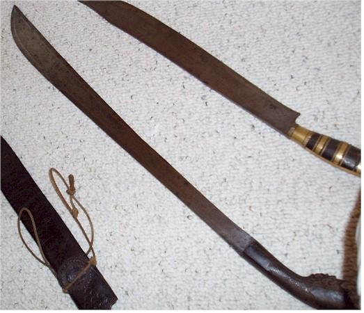 Sword 11- Hulu Tapa Guda Klewang- Sumatra. Long blade with partial bevel along the top.