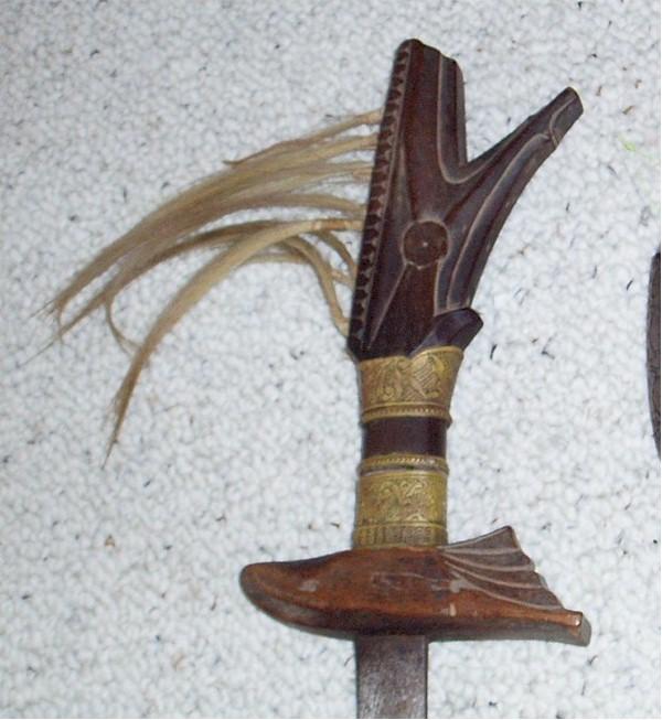 Crocodile handle adorned with blond horse hair and brass or copper