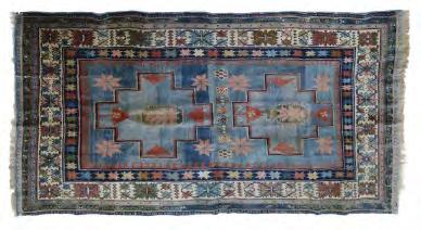 Lot 412 20th Century Persian wool rug or carpet, the red field with central flowerhead medallion within further flowering plant motifs, matching