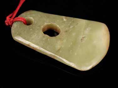 close the the edge with a string attached, the stone of celadon tone with white and russet inclusions,accompanied with a box. L:7.5, H:0.