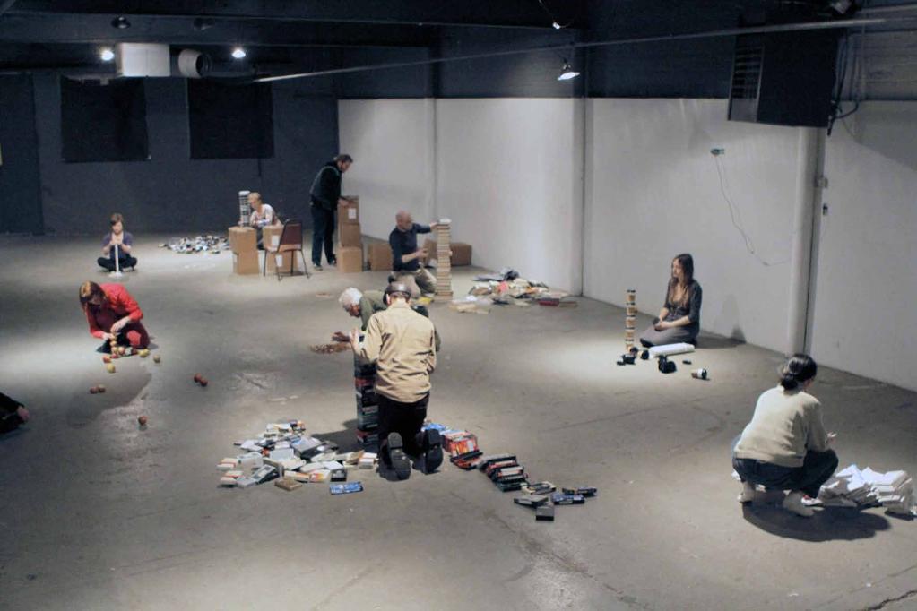 12. Stacking performance, 2013 duration 60 min. The space is empty. The whole action takes place between 8 and 9 p.m. At 8 p.m. the stackers bring in their items and pile it on the floor, each choosing their own spot near a light.