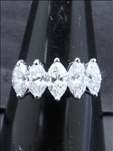 Lot: 239 R304 A 18K WHITE GOLD RING set with a row of five marquise diamonds weighing 1.29cts, good high colour and clarity. Total weight 2.58gm. 18K 白金戒指含一行五颗橄贱钻石, 重 1.