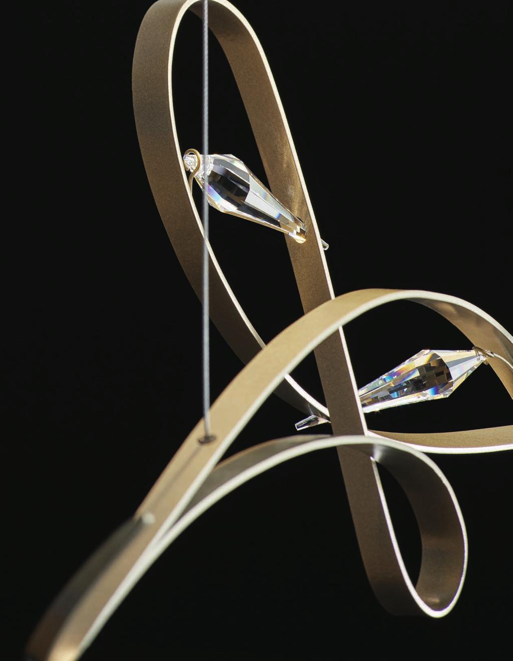 Flowing ribbons of steel are pierced by cone-shaped Swarovski
