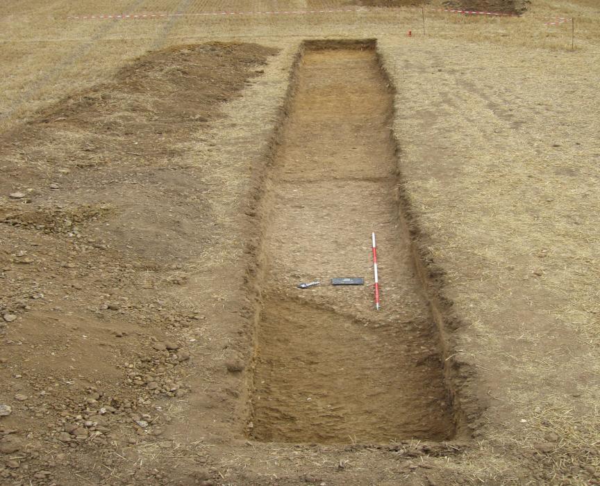 Figure 12: Trench D showing the two different types of metalled surface, 1 & 2 Photo taken by Rhw Mitcheson.