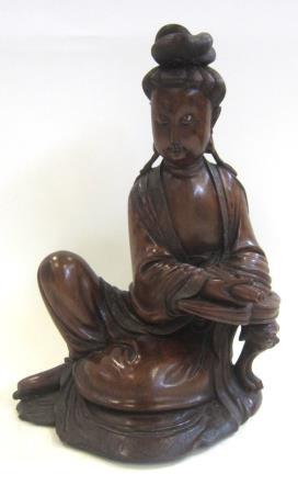 5 cms long 100-150 167. A good quality Chinese carved wood model of Guanyin, seated, her right hand holding a scroll. 27 cms high 100-150 168.