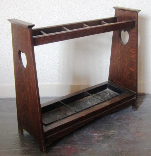 An Art Nouveau style oak rectangular fivedivision Umbrella/Stick Stand with inset metal drip tray, width 79 cms 30-40 455.