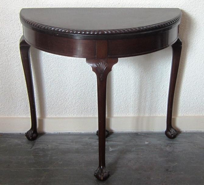 Lot 480 480. A mahogany demi-lune foldover Card Table with pie crust border, the four tapering supports raised on claw and ball feet. Width 82 cms 70-100 481.