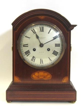 30.5 cms high 523. An Edwardian inlaid mahogany Mantel Clock.The dial signed "John Elkan, 35 Liverpool Street, City".38 cms high (lacking moulding to one side of case) 524.