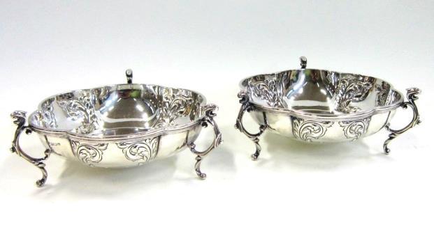 A pair of late Victorian pierced silver Dishes. Saunders and Shepherd, Birmingham, 1895. Die-stamped with a putto amongst flowers, foliate border 11 cms diameter, 2 1/2 oz (88 gr) Lot 103 103.