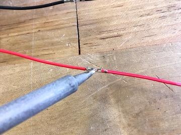 heat shrink tubing Slide another piece of heat shrink tubing over each wire, then
