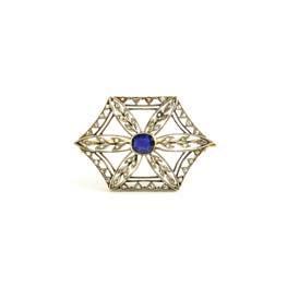 brooch, formed as a stylized blossom of rose-cut diamond-set leaves centering a bezel-set sapphire within a hexagonal frame, set