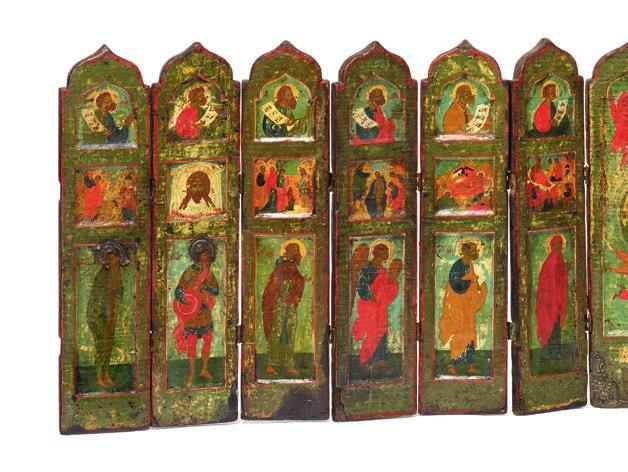 737 737 RUSSIAN ICON, LATE 18TH CENTURY An interesting large Russian folding and travelling iconostasis icon consisting of 13 panels, Christ in a green Mandorla raised to the sky by God supported by