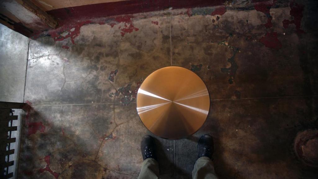 A metal stool sits in the middle of a tiny A Block cell for Ai Weiwei's sound installation