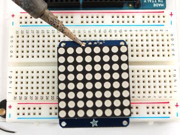 Place the soldered backpack on top of the header. Solder the four pins That's it! now you're ready to run the firmware! (http://adafru.
