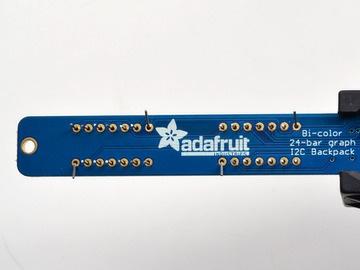 Turn over the PCB and bend opposite-corner pins of the modules out so that the modules are
