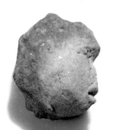 it appears more crude than most of the other heads. The forehead has a slight protuberance or bump on it, as though to convey an injury or deformation.
