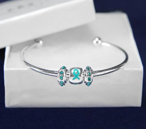 A flexible bangle bracelet that has the words Mother, Daughter, Sister, Aunt, Friend with teal ribbons.