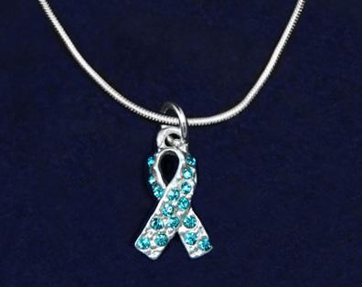 This sterling silver plated necklace is a 17 inch snake chain with a lobster clasp that has a crystal teal ribbon charm.