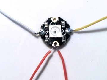 Solder a white wire to the "in" hole and a yellow wire to the "out" hole of each neopixel.