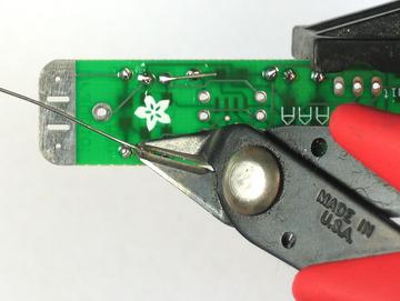 Clip the leads. Next is the heart of the kit, a low voltage 555 timer chip. This one is called the TLC551. The important thing to note about the chip is that it is not symmetric.