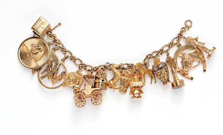 490 490 Gold Charm Bracelet, suspending fifteen 18kt and 14kt gold charms including a Liteacharm lantern and crab, horse and horseshoe charms, a Mad Money box, Tuesday s Child, signed Ruser, an