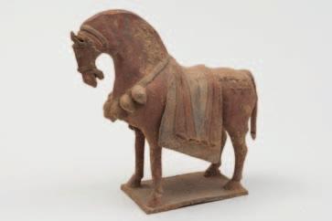 505 A Chinese pottery horse modelled standing four square with arched neck, wearing bridle, a row of water