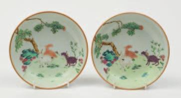 535 535 A pair of Chinese small saucer dishes painted in famille rose enamels with three goats in a landscape, a gnarled tree and rockwork in the background, the underside
