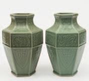 538 539 542 541 538 A pair of Chinese celadon vases of hexagonal baluster form, relief moulded with dragons, classical scrolls and pendant stiff leaves, 30cm high.