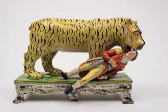 580 A rare Staffordshire pearlware group of The Death of Munrow in the manner of Obadiah Sherrat, modelled as a large tiger attacking the stricken Lieutenant Munrow, on rectangular base with bracket
