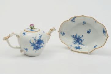 615 614 614 A Meissen teapot and cover and matching dish the bullet-shaped teapot with wishbone handle and basketwork border, painted in blue