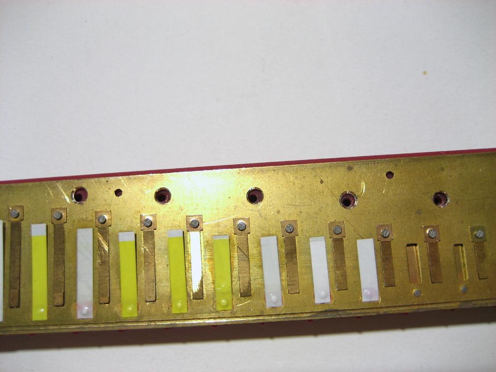 When you enlarge the holes on the top reedplate you may still have a couple of holes that aren't perfectly lined up.